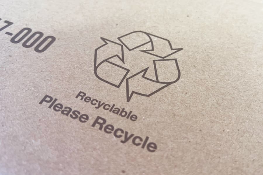 Cardboard with Recle Symbol and "Recyclable" and "Please Recycle" printed on the cardboard