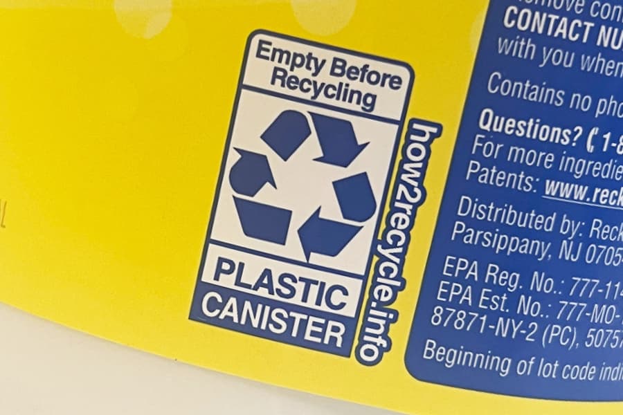 plastic container with a dark blue and white how2recycle label on a yellow background showing instructions on how to recycle the container