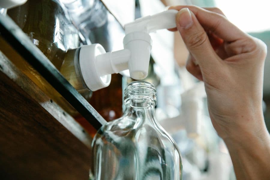 Glass bottle being used for product refill