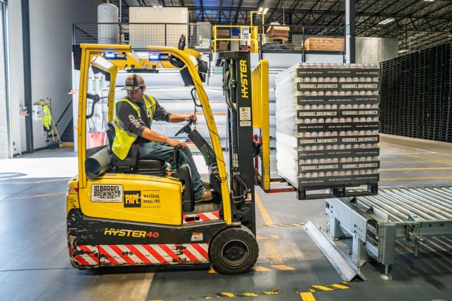 forklift operator moving pallet pf product