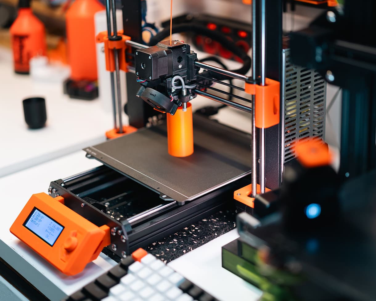 3D printer creating a packaging prototype in a workshop