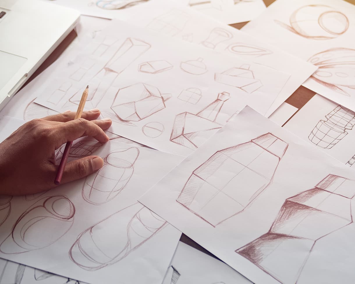 Bottle design being drafted on paper