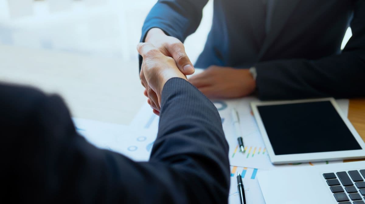 Business managers shaking hands in agreement