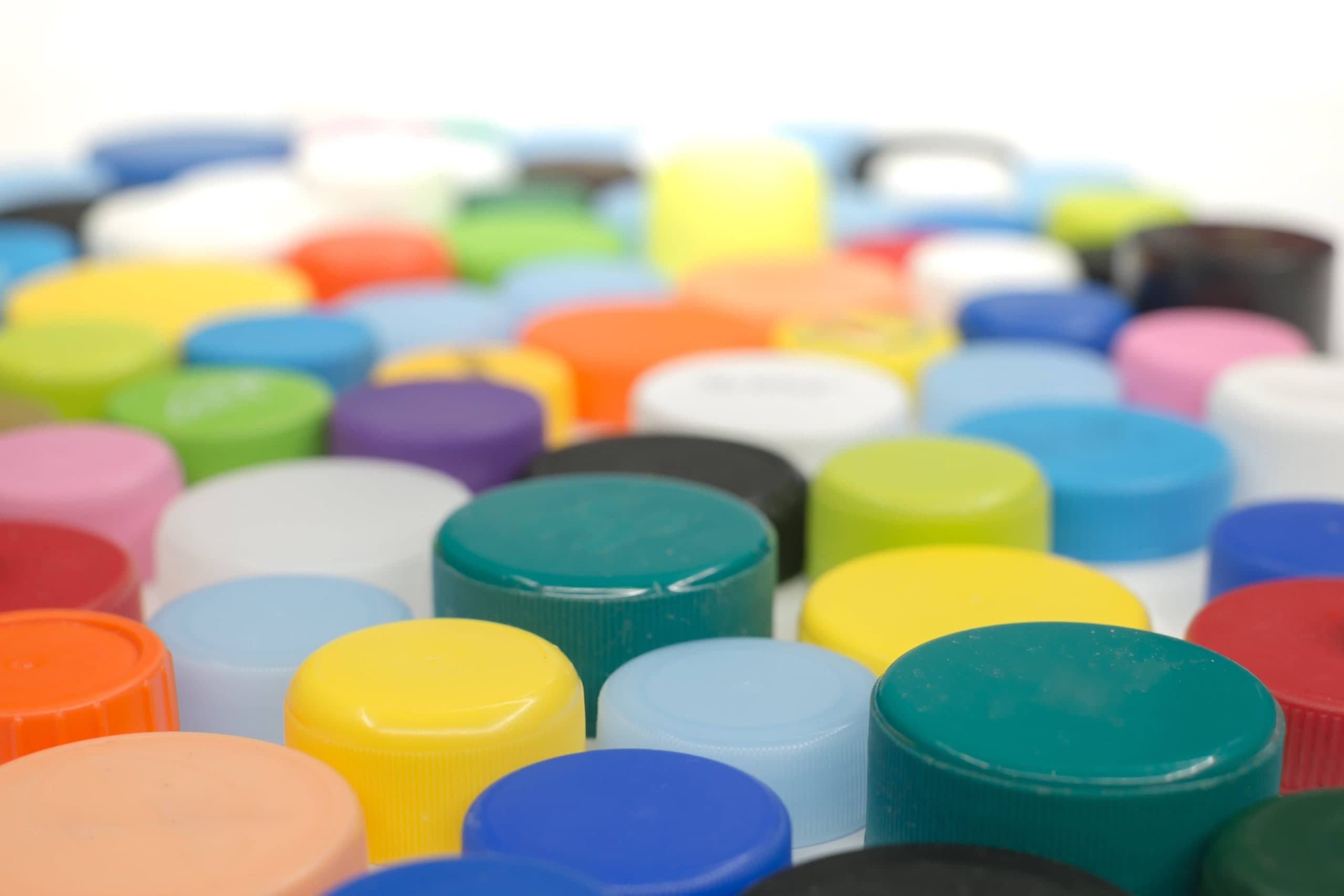 image shows a grouping of different colors of plastic cap closures
image credit: Colorful Bottle Caps Photo by Roberto Sorin on Unsplash