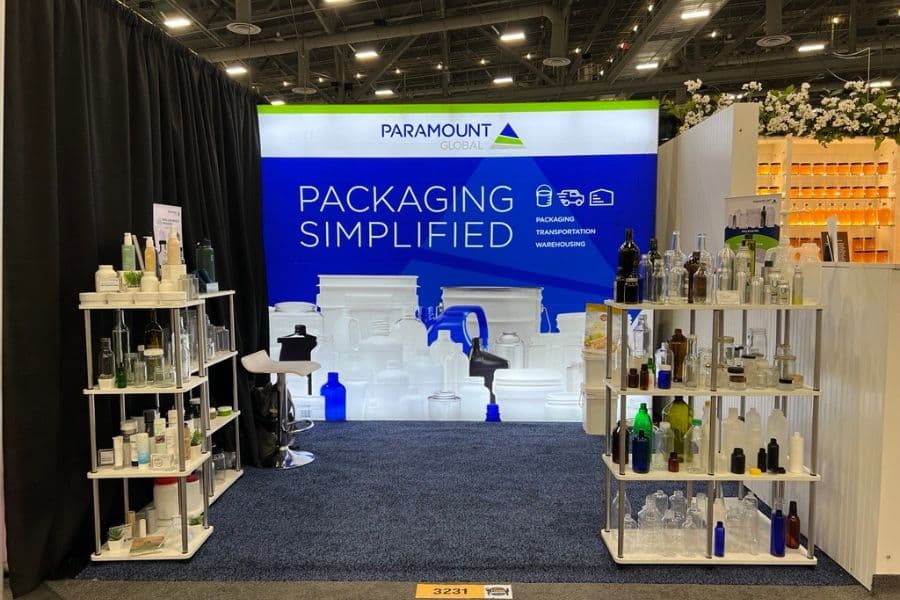 Paramount Global's booth at the Winter Fancy Food Show 2024 shows a lit backdrop that reads "packaging simplified" and shelves lined with packaging options.