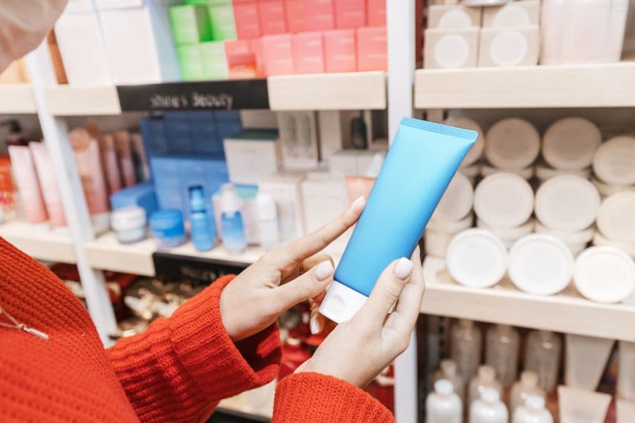 a person holds a tube of a personal care product