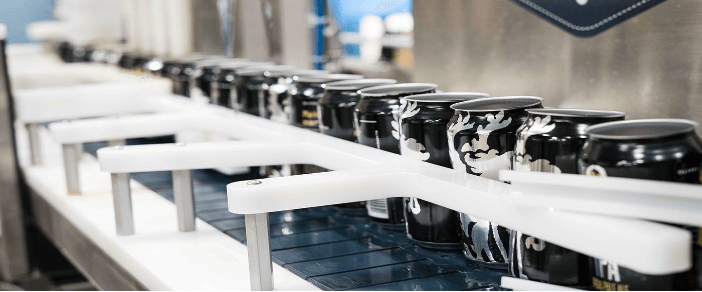 Image of empty beverage cans in assembly line