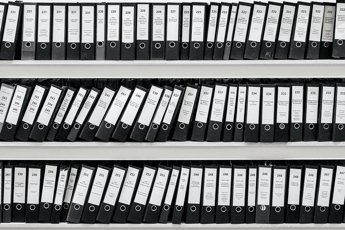 Image of bookshelf filled with binders of paperwork