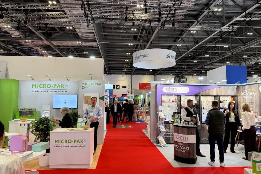 London Packaging Week show floor with red carpet and trade show booths on either side of the aisle