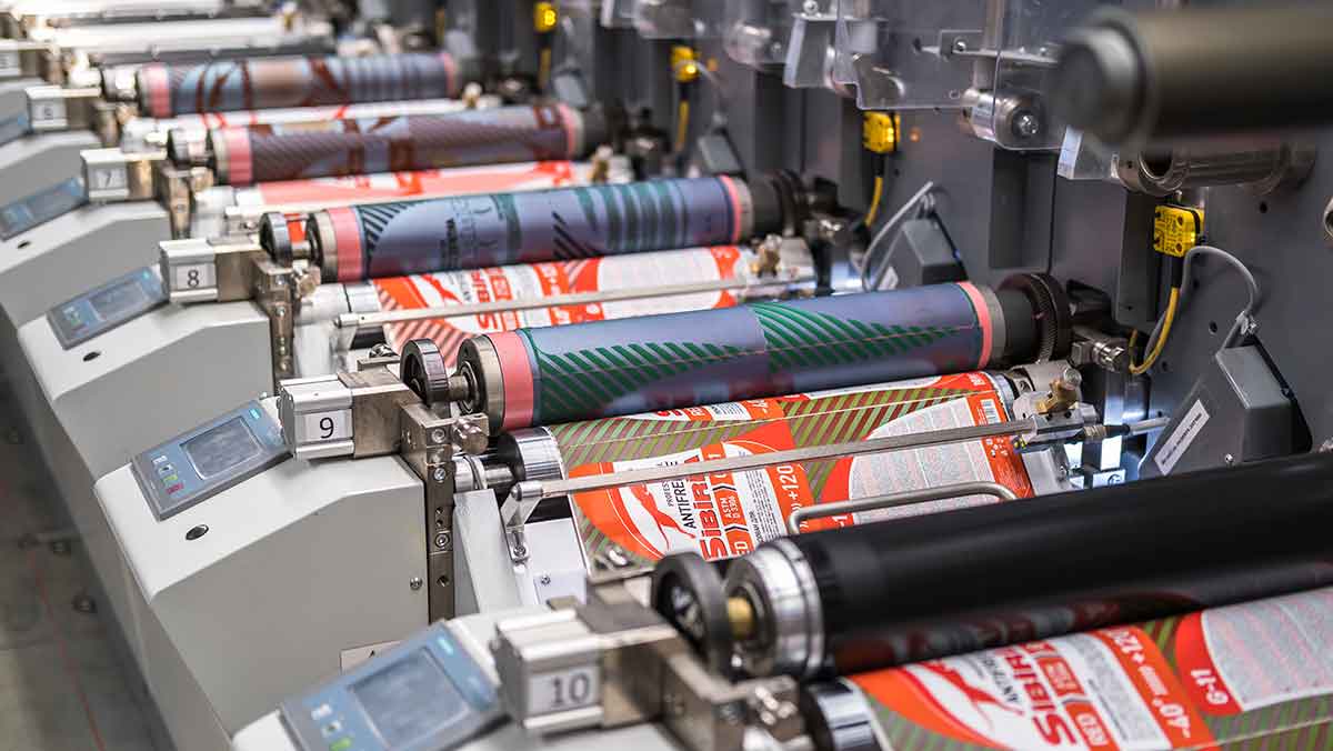 canisters being labeled with automatic label machine.